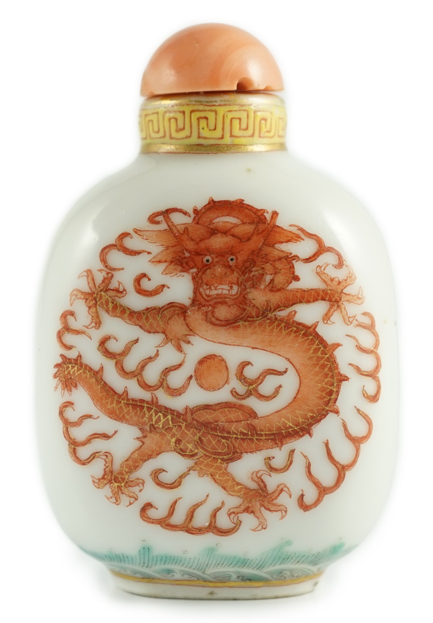 A Chinese enamelled porcelain ‘peacock and dragon’ snuff bottle, Jiaqing mark and period (1796-1820), 5.6cm high, coral stopper and wood stand